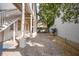 Picturesque courtyard featuring brick-paved walkway, white columns, stairs, and lush greenery at 38 State St # 2, Charleston, SC 29401