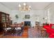 Charming dining room with a fireplace, chandelier, and hardwood floors, perfect for gatherings and entertaining at 38 State St # 2, Charleston, SC 29401