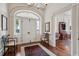 Grand foyer with arched doorway, chandelier, and hardwood floors, creating a welcoming entrance to the home at 38 State St # 2, Charleston, SC 29401