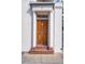 Elegant wooden front door featuring traditional design, columns, and number 38, adding to the home's curb appeal at 38 State St # 2, Charleston, SC 29401