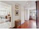 Hallway with hardwood floors and doorway views to the bathroom at 38 State St # 2, Charleston, SC 29401