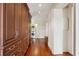 Hallway with wooden cabinetry, a stacked washer/dryer, and hardwood floors at 38 State St # 2, Charleston, SC 29401
