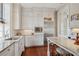 Kitchen with white cabinets, stainless steel appliances, and a breakfast table with granite countertop at 38 State St # 2, Charleston, SC 29401