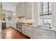 Bright kitchen featuring stainless steel appliances, granite countertops, and white cabinetry at 38 State St # 2, Charleston, SC 29401
