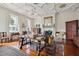 Elegant living room featuring ornate ceiling, fireplace, hardwood floors, and period furniture at 38 State St # 2, Charleston, SC 29401