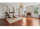 Spacious main bedroom with a four-poster bed, chandelier, and hardwood floors at 38 State St # 2, Charleston, SC 29401