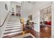 Elegant staircase with wooden steps and white risers, complemented by hardwood floors and natural light at 38 State St # 2, Charleston, SC 29401
