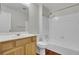 Bathroom vanity with wood cabinets, white countertop, and a tub with a shower head at 402 Andrea Ln, Hanahan, SC 29410