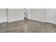 Spacious bedroom features modern hardwood floors, white walls, and access to the laundry room at 402 Andrea Ln, Hanahan, SC 29410