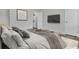 Comfortable bedroom showcasing calming colors, a television, and access to the laundry room at 402 Andrea Ln, Hanahan, SC 29410