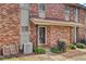 Brick exterior of an apartment building showcasing well-maintained landscaping and charming entrance at 402 Andrea Ln, Hanahan, SC 29410