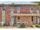 Brick exterior of an apartment building showcasing updated exterior and well-maintained landscaping at 402 Andrea Ln, Hanahan, SC 29410