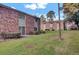 Exterior of building surrounded by a large, green lawn, and mature trees at 402 Andrea Ln, Hanahan, SC 29410