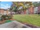 Brick apartment buildings with grassy area and trees create a welcoming, tranquil environment at 402 Andrea Ln, Hanahan, SC 29410