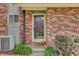 Up-close exterior showcasing the front door, updated exterior, and manicured landscaping at 402 Andrea Ln, Hanahan, SC 29410
