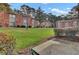 Exterior view of the apartment building, enhanced by a lush lawn and shrubbery at 402 Andrea Ln, Hanahan, SC 29410
