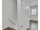 Bright hallway features white walls, a staircase, and light wood-look flooring near the door to another room at 402 Andrea Ln, Hanahan, SC 29410