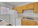 Bright kitchen features white refrigerator, new wood cabinets, sink and stainless steel appliances at 402 Andrea Ln, Hanahan, SC 29410