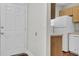 Efficient kitchenette features a white refrigerator and cabinetry next to the front door at 402 Andrea Ln, Hanahan, SC 29410
