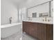 Elegant bathroom showcasing a freestanding tub, marble floors, and a double vanity with modern fixtures at 4057 E Amy Ln, Johns Island, SC 29455