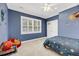 Cozy bedroom showcases a ceiling fan, carpeted floors, a large window, and colorful decor at 4057 E Amy Ln, Johns Island, SC 29455
