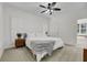 Bright bedroom featuring a ceiling fan, plush carpeting, and ensuite bath with natural light at 4057 E Amy Ln, Johns Island, SC 29455