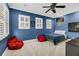 Inviting bedroom features blue walls, wood floors, a ceiling fan, and natural light from windows at 4057 E Amy Ln, Johns Island, SC 29455