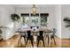 Bright dining room with hardwood floors, a rustic wood table, and natural light from large windows at 4057 E Amy Ln, Johns Island, SC 29455