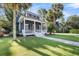 Inviting two-story home with white picket porch, lush lawn, mature trees, and ample curb appeal at 4057 E Amy Ln, Johns Island, SC 29455