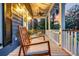 Relaxing front porch featuring a ceiling fan, rocking chairs, and serene outdoor ambiance at 4057 E Amy Ln, Johns Island, SC 29455