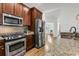 Modern kitchen with stainless steel appliances, granite countertops, and hardwood floors leading to living area at 4057 E Amy Ln, Johns Island, SC 29455