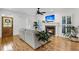 Bright living room with a cozy fireplace, plantation shutters, and stylish hardwood floors at 4057 E Amy Ln, Johns Island, SC 29455