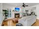 Bright living room featuring a cozy fireplace, plantation shutters, and hardwood floors at 4057 E Amy Ln, Johns Island, SC 29455