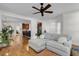 Spacious living room with hardwood floors, ample seating, and an open layout to the kitchen at 4057 E Amy Ln, Johns Island, SC 29455