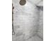 Detail of a luxurious marble shower with a rainfall showerhead and built-in bench at 4057 E Amy Ln, Johns Island, SC 29455