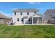 Back of house featuring a screen porch, patio and spacious green lawn, creating an inviting outdoor space at 415 Ribiero Dr, Summerville, SC 29486