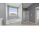 A bathtub with a window next to a shower in the bathroom at 415 Ribiero Dr, Summerville, SC 29486