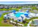 Aerial view of a community pool and amenity center with wading pool and splash pad with chairs and umbrellas at 415 Ribiero Dr, Summerville, SC 29486