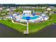 Aerial view of a luxury community pool, splash pad and wading pool with lakefront pier access at 415 Ribiero Dr, Summerville, SC 29486
