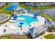 A full aerial view of a community pool, splash pad and wading pool with umbrellas and lounge seating at 415 Ribiero Dr, Summerville, SC 29486