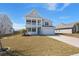 Inviting two-story home with a double porch, attached garage and a lush green lawn perfect for outdoor activities at 415 Ribiero Dr, Summerville, SC 29486