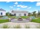 Community fire pit with seating area and picnic tables surrounded by beautiful green space and charming building at 415 Ribiero Dr, Summerville, SC 29486