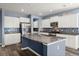 Modern kitchen with white cabinets, stainless steel appliances, and large granite island at 415 Ribiero Dr, Summerville, SC 29486