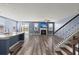 Open-concept living space with a kitchen island, fireplace, hardwood floors, and natural light at 415 Ribiero Dr, Summerville, SC 29486