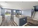 Open-concept living room features a kitchen island, fireplace, and access to the backyard at 415 Ribiero Dr, Summerville, SC 29486