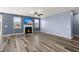 Bright living room with a fireplace, hardwood floors, and a ceiling fan, perfect for relaxation and entertainment at 415 Ribiero Dr, Summerville, SC 29486