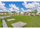 Community playground with modern play structures, horseshoe pit, benches and lush green grass under a partly cloudy sky at 415 Ribiero Dr, Summerville, SC 29486