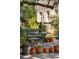 Serene backyard patio area with iron table and chairs surrounded by potted plants at 42 Barre St, Charleston, SC 29401