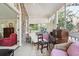 Covered balcony offers a peaceful retreat with comfortable seating, desk, and bright light at 42 Barre St, Charleston, SC 29401