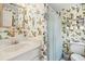 Bathroom with patterned wallpaper, shower curtain, and open shelving at 42 Barre St, Charleston, SC 29401